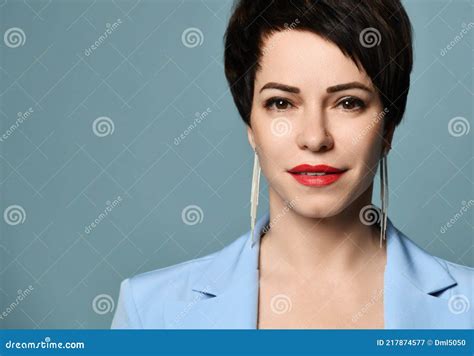 Portrait Of Friendly Smiling Short Haired Brunette Woman In Blue