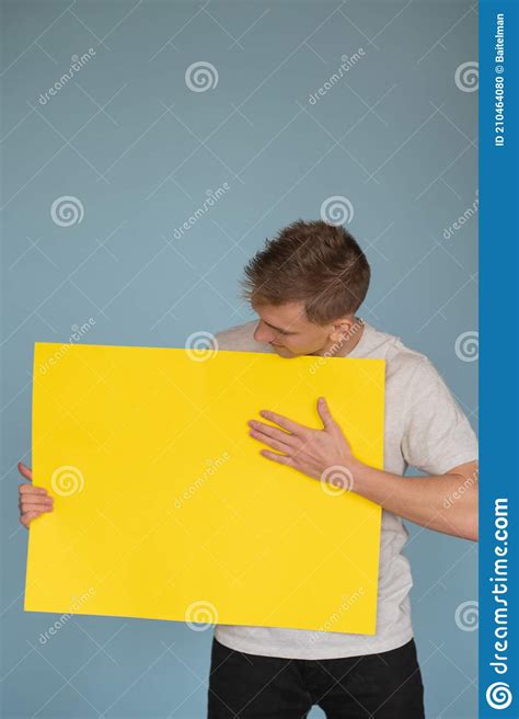 Happy Smiling Young Man Showing Blank Signboard With Empty Copyspace