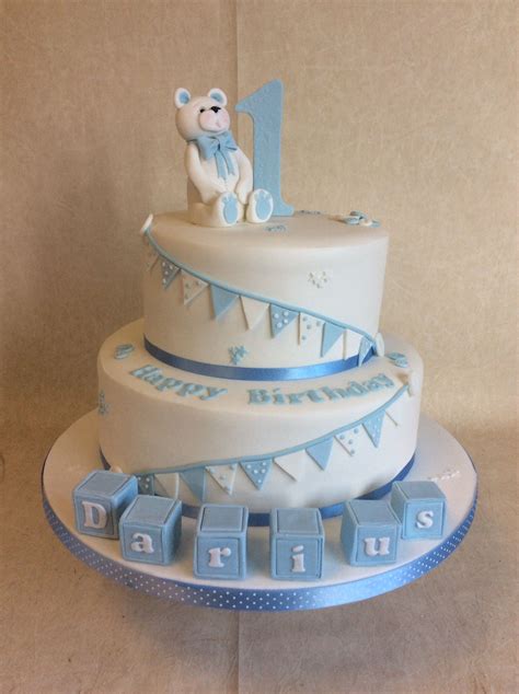 Be sure to check out our free birthday invitations when it's time to plan a special birthday party. 2 tier Baby Blue & white 1st birthday cake with blocks, bunting and bear! | Baby birthday cakes ...