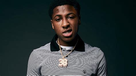 Nba Youngboy Is Wearing Black White Striped T Shirt In Green Background