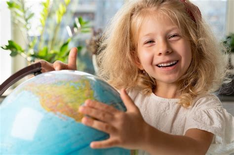 Premium Photo Little Girl With A Globe Study Geography Back To School
