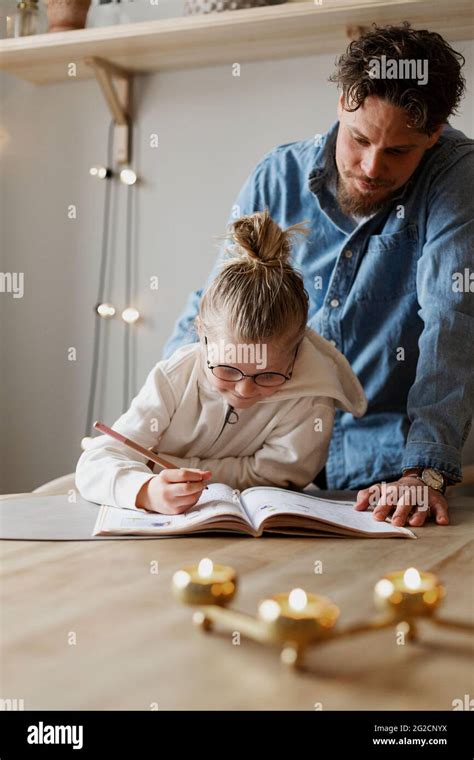 Father Helping Daughter Doing Homework Stock Photo Alamy
