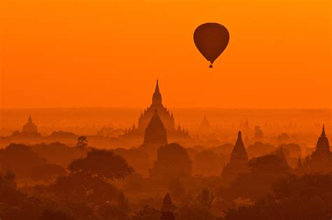 Hot Air Balloon Flying Over The Temples Of Bagan Burma At Sunrise