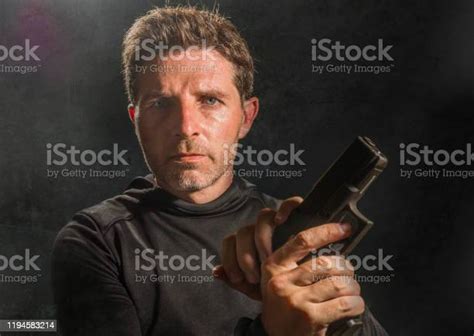 Action Portrait Of Serious And Attractive Hitman Or Special Agent Man