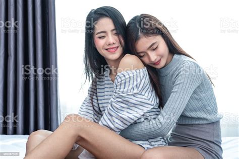 Two Asian Lesbian Women Hug And Embracing Together In Bedroom Couple
