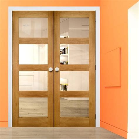An Orange Room With Two Wooden Doors And Bookshelves