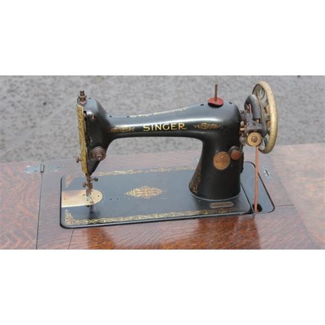 An Antique Oak And Cast Iron Singer Sewing Machine Table With Machine