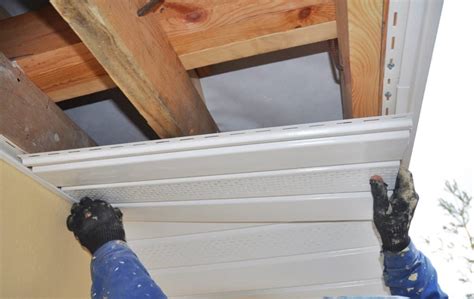 Measuring wall with measuring tape and marking area to work on in this home improvement project. What is Soffit and Why Does My Home Need It? - Thompson Creek