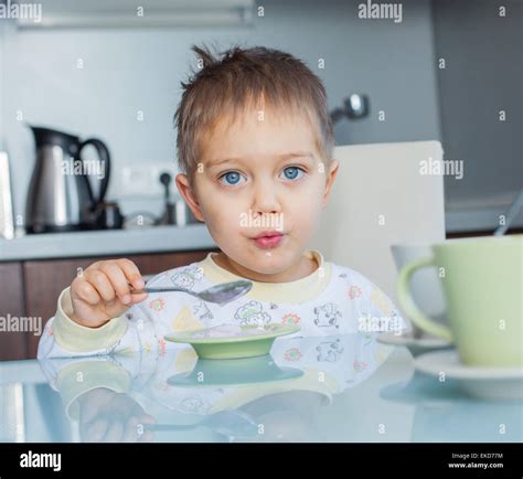Happy Boy Eating Breakfast Stock Photo Alamy