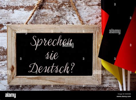 A Wooden Framed Chalkboard With The Question Sprechen Sie Deutsch Do