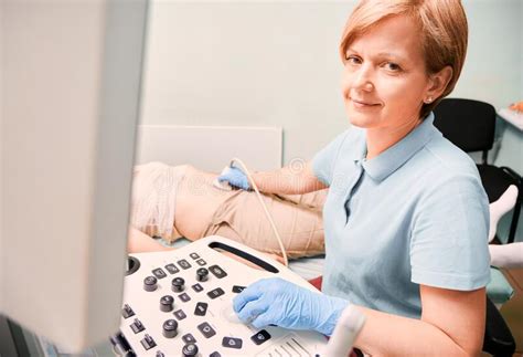 Female Doctor Doing Ultrasound Examination In Clinic Stock Image