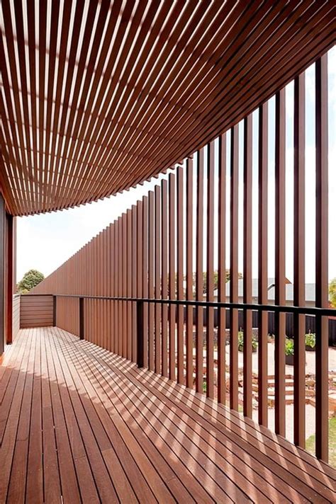 Rectangular Wooden House With Slatted Circular Facade