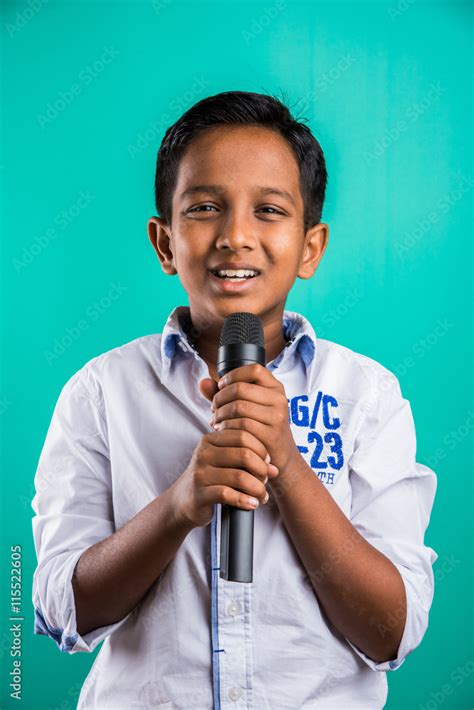 Young Indian Boy In White Shirt Yelling In Microphone Little Kid