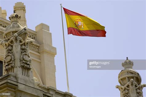 Low Angle View Of A Spanish Flag Fluttering On A Building Madrid Spain