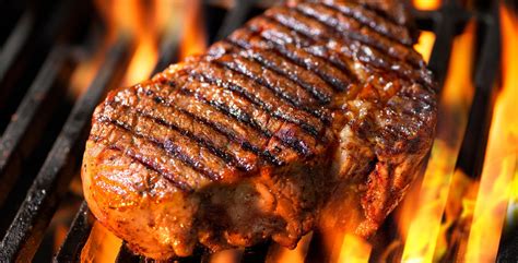 Beef Steak On The Grill With Flames Bbq Tips