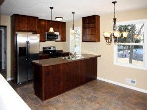 Subway tile, white cabinets with glass doors stainless refrigerator, bar stools, wood floors. Kitchen White Trim Dark Cabinets | W4794 County Rd O ...