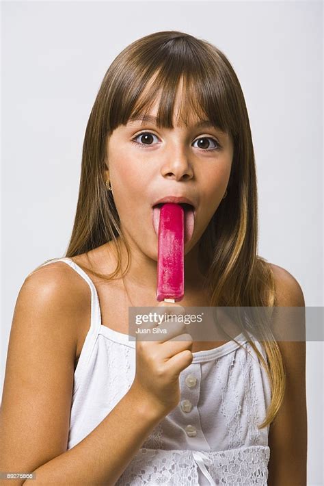 Girl Eating A Popsicle Portrait High Res Stock Photo Getty Images
