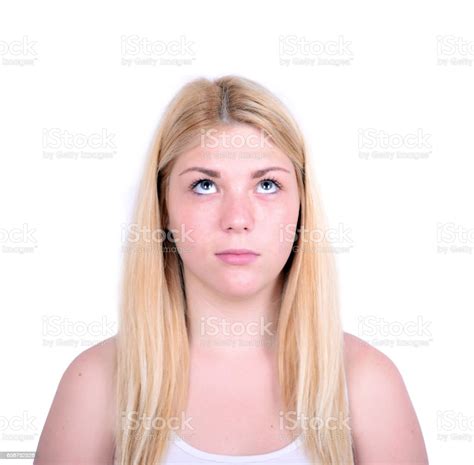 Portrait Of Beautiful Girl Looking Up Against White Background Stock