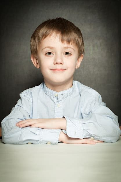 Premium Photo Happy Little Boy Sitting In School Classroom