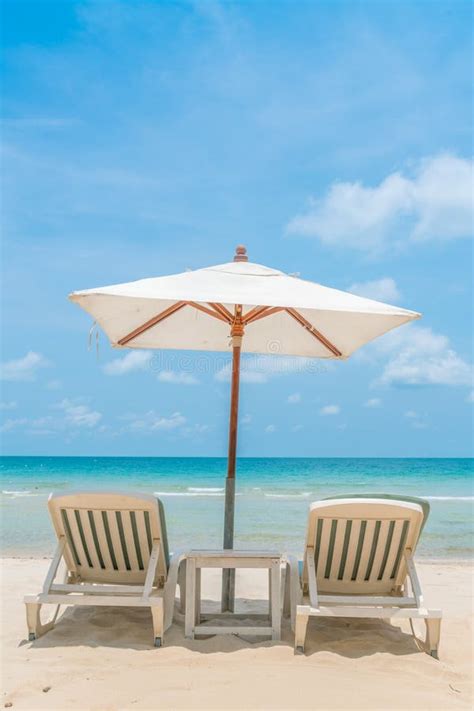 Beautiful Beach Chairs With Umbrella On Tropical White Sand Beach Stock
