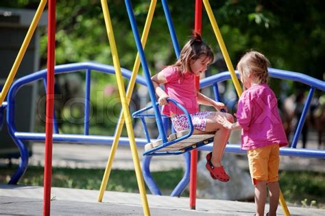 Children playing on playground in park | Stock Photo | Colourbox