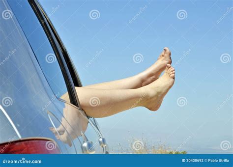 Women With Bare Feet Out The Window Of The Car Stock Photography