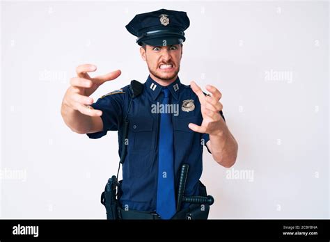 Young Caucasian Man Wearing Police Uniform Shouting Frustrated With