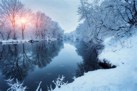 Winter Forest On The River At Sunset Colorful Landscape With Snowy