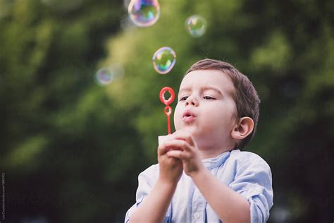Cute Babe Babe Blowing Bubbles In A Park By Stocksy Contributor Lea Csontos Stocksy
