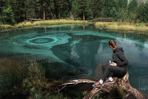 Woman At Beautiful Geyser Lake With Thermal Springs That Periodically