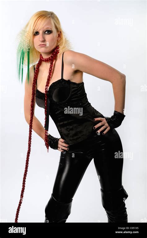 Blond Woman In Black Bustier And Latex Pants And Boots On A Leash Stock