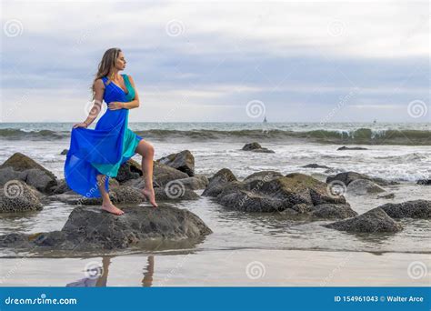 Lovely Brunette Latin Model Poses Outdoors On A Beach At Sunset Stock