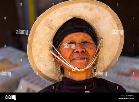 Chinese Farmer Woman Wearing Straw Hat At The Market In Rural