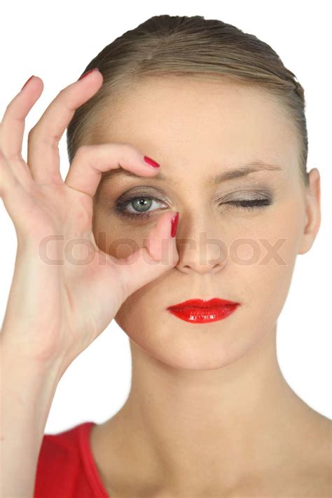 Woman Making A Circle With Her Fingers Around Her Eye Stock Image