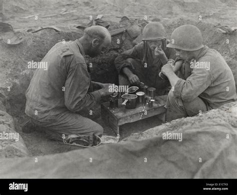 Three Us Army Soldiers Eat Rations In A Foxhole During The Battle