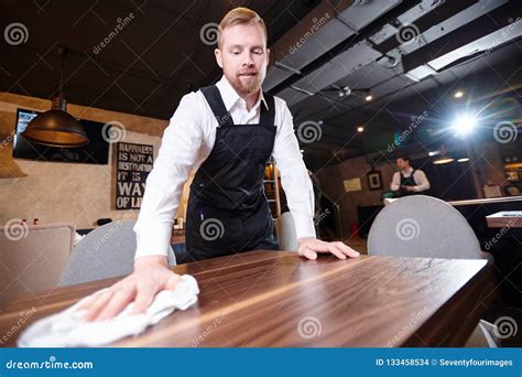 Handsome Young Waiter Cleaning Table In Restaurant Stock Photo Image