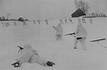 Soviet infantry in winter camouflage, approaching a village in the ...