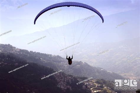 Paraglider Flying Over A Himalayan Valley During The Sikkim Paragliding