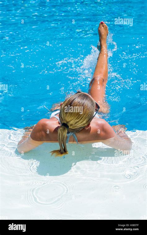 Woman At The Swimming Pool Splashing Water With Her Legs Stock Photo Alamy