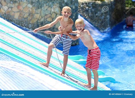 Two Happy Brothers Having Fun In Aqua Park Stock Photo Image Of