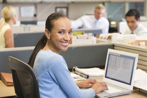 Businesswoman Cubicle Using Laptop Smiling Stock Photo By