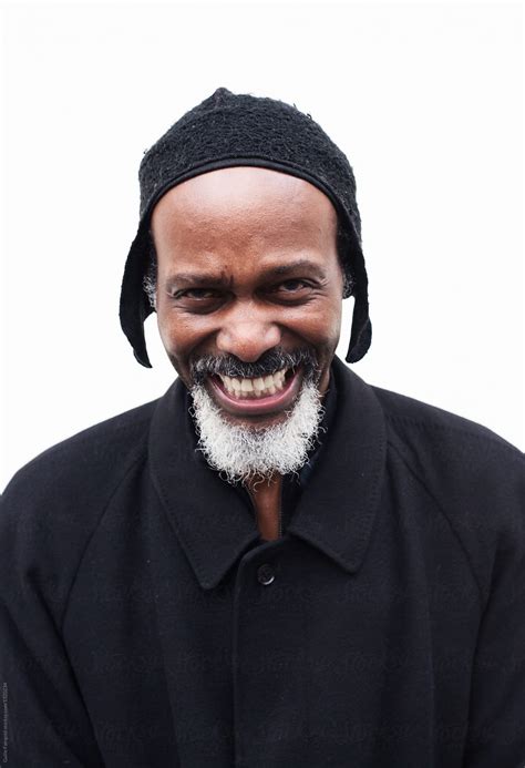 Senior Black Man Laughing At Camera By Stocksy Contributor Guille