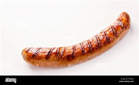 Side View Of Curved Single German Bratwurst Sausage On White Background