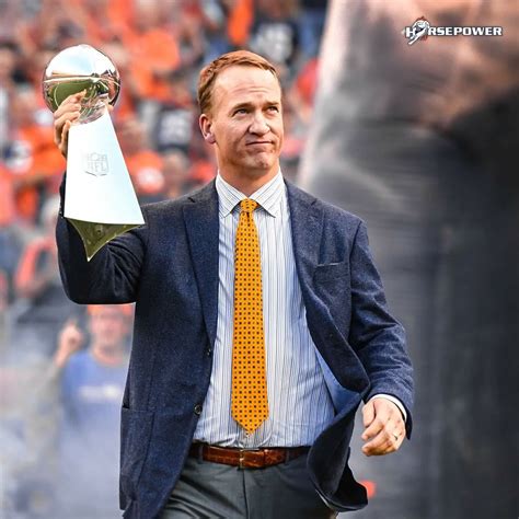 Super Bowl Champion Peyton Manning Carries Lombardi Trophy On Broncos