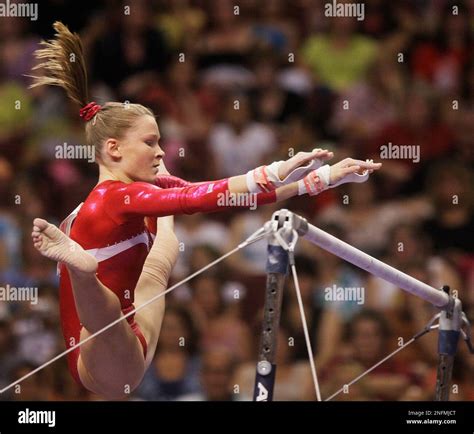 Bridget Sloan Reaches Out To Grab The Uneven Bars During The Womens