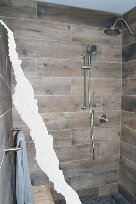 A Bathroom With A Wooden Shower Stall And Tiled Walls