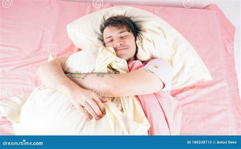 A Young Handsome Man Lies In Bed And Sweetly Falls Asleep The Man