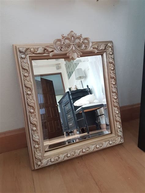 A Mirror Sitting On Top Of A Wooden Floor