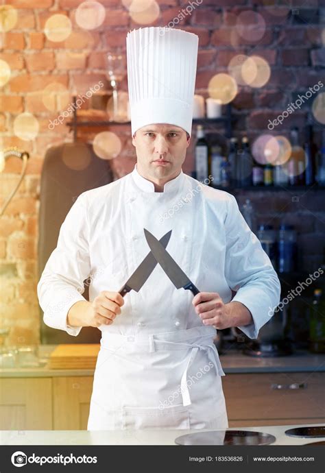 Happy Male Chef Cook In Kitchen With Knife Stock Photo By ©syda