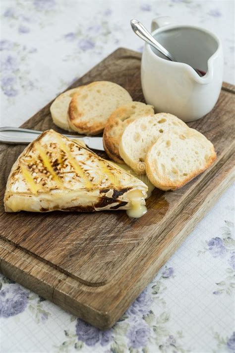 Slice Of Grilled Camembert With Toasted Baguettes And Cranberry Stock